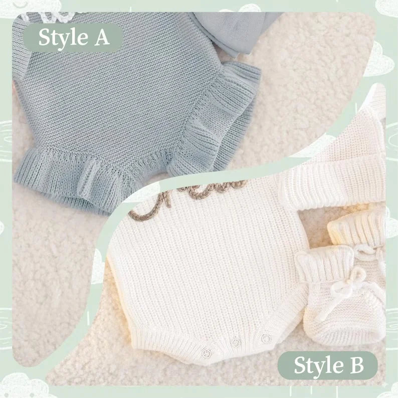 Two coordinated baby knit outfits displayed on a soft cream background, labeled Style A and Style B. Style A shows a light blue bodysuit with ruffled trim; Style B shows an off-white bodysuit with decorative lettering and matching off-white hat and booties.