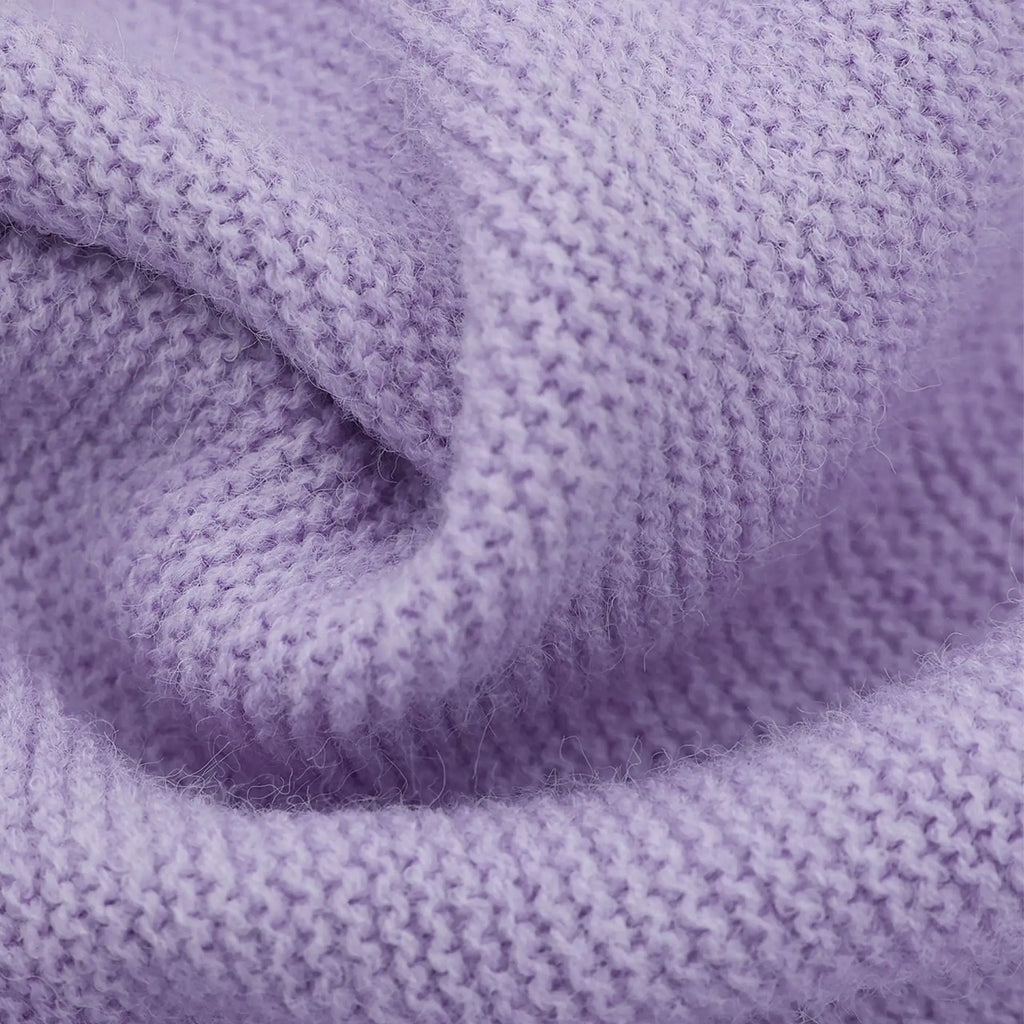Close-up of a folded purple blanket with textured fabric.