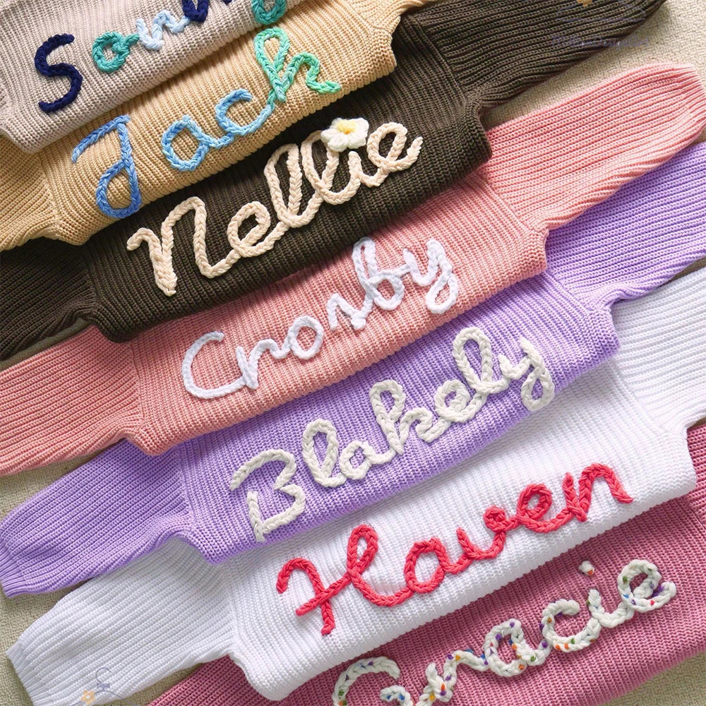 Stack of colorful socks with embroidered names on a neutral background